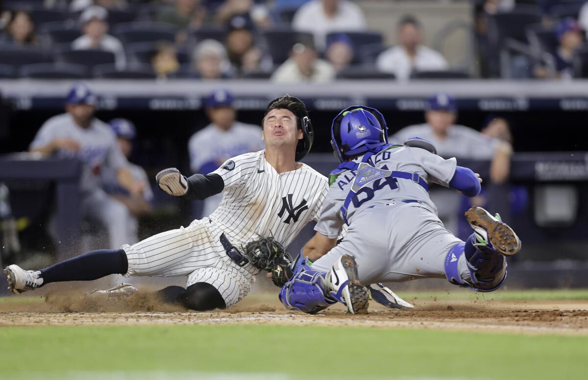 Dodgers catcher Eliezer Alfonzo tags out Yankees runner Anthony Volpe at the plate in the fourth inning.