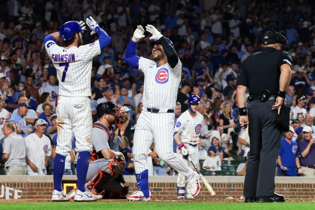 Chicago Cubs shortstop Dansby Swanson celebrates with Michael Conforto after Conforto hit a two-run home run during the fifth inning against the Detroit Tigers at Wrigley Field on July 21, 2026, in Chicago. (Armando L. Sanchez/Chicago Tribune)