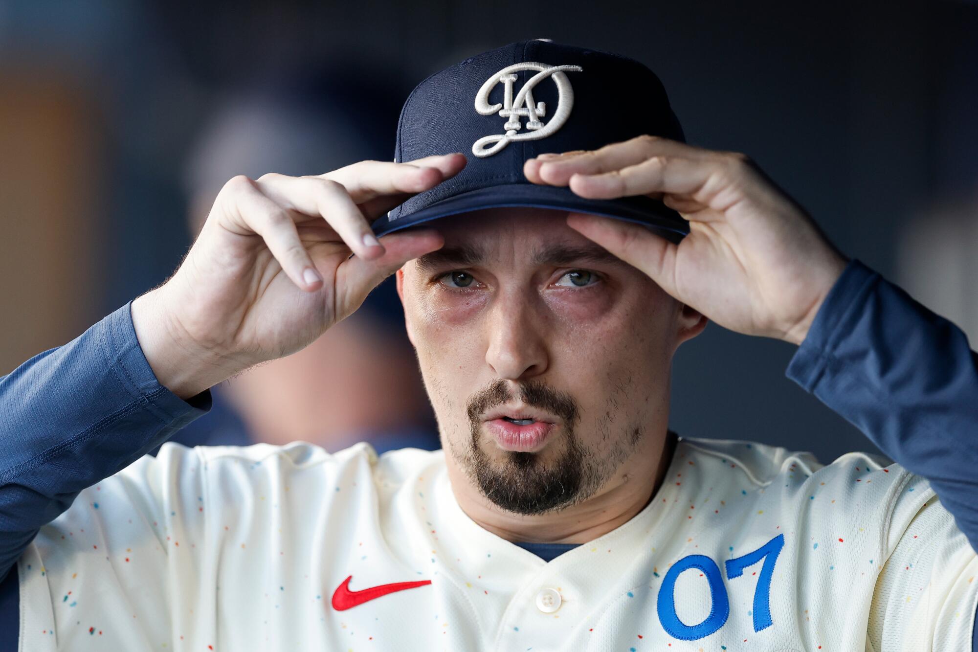 Dodgers starting pitcher Blake Snell puts on his cap before a game against the Atlanta Braves on May 9.
