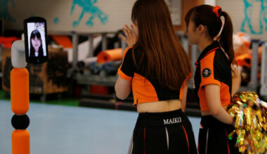 Yomiuri Giants cheerleaders talk to a fan, Futaba Tsuchiya, on a monitor during their game against Hiroshima Toyo Carp, held without spectators due to the spread of the COVID-19 at Tokyo Dome in Tokyo, Japan June 23, 2020.