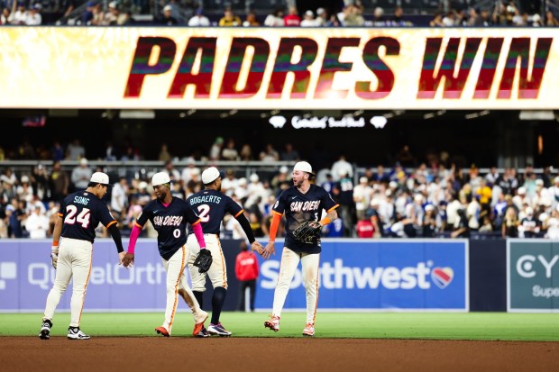 From left, the San Diego Padres' Sung-Mun Song, Samad Taylor, Xander Bogaerts and Jackson Merrill celebrate after a 7-1 victory over the Dodgers on Friday, June 26, 2026, in San Diego. (AP Photo/Derrick Tuskan)