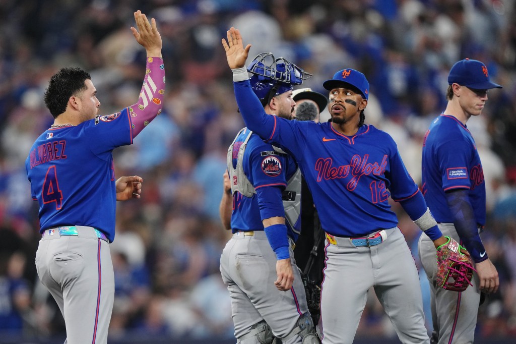 New York Mets' Francisco Alvarez (4) and Francisco Lindor (12) celebrate after defeating the Toronto Blue Jays during a baseball game in Toronto on Tuesday, June 30, 2026. (