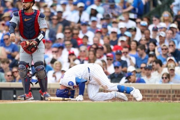 Chicago Cubs third baseman Alex Bregman (3) falls in pain after fouling a ball off his foot during the sixth inning against the St. Louis Cardinals at Wrigley Field on Sunday, July 5, 2026. (Eileen T. Meslar/Chicago Tribune)