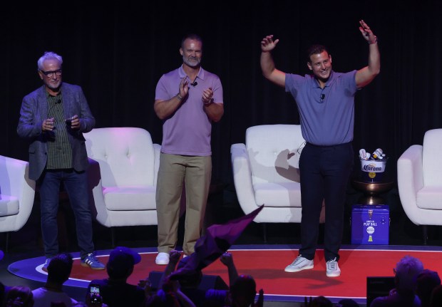 Former Cubs manager Joe Maddon, from left, with former players David Ross and Anthony Rizzo are introduced for "The Lovable Reunion Live" at the Chicago Theatre on July 16, 2026. (John J. Kim/Chicago Tribune)