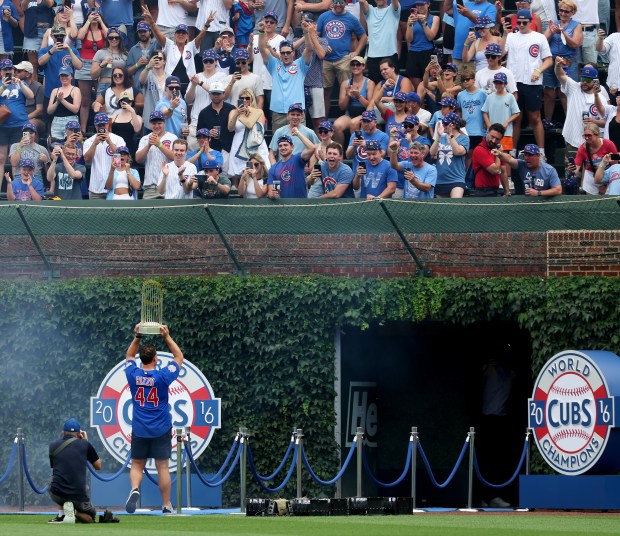 Anthony Rizzo carries the World Series trophy as the 2016 Cubs are honored before a game against the Twins on July 18, 2026, at Wrigley Field. (Chris Sweda/Chicago Tribune)