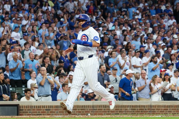 Cubs right fielder Seiya Suzuki (27) scores off a two RBI single from Cubs catcher Carson Kelly (15) during the first inning at Wrigley Field July 21, 2026 in Chicago. (Armando L. Sanchez/Chicago Tribune)