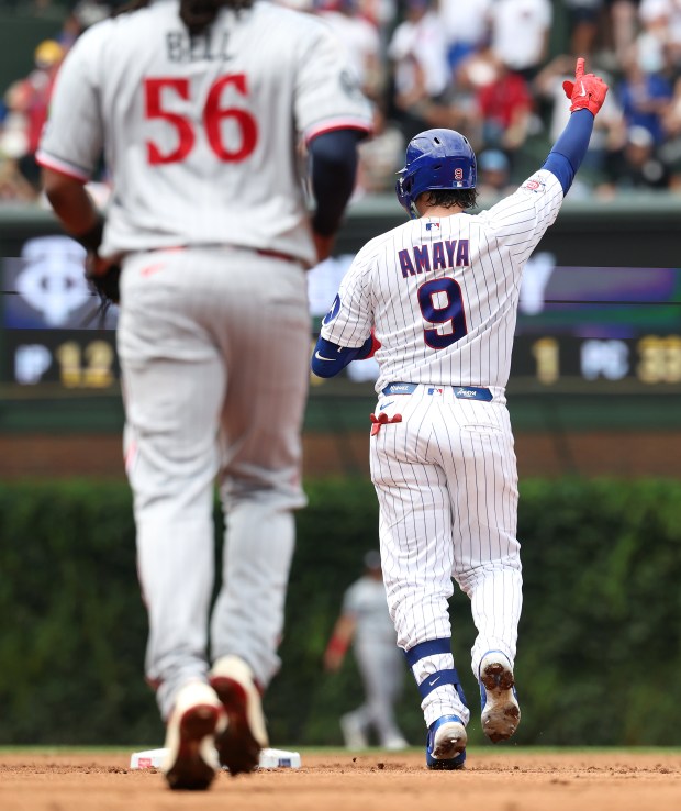 Cubs catcher Miguel Amaya celebrates as he pulls up at second base with a two-run double in the second inning against the Twins on July 18, 2026, at Wrigley Field. (Chris Sweda/Chicago Tribune)
