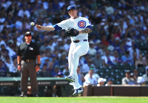 Cubs reliever Jacob Webb spins and throws to first base on an infield single for Twins first baseman Josh Bell in the ninth inning on July 18, 2026, at Wrigley Field. (Chris Sweda/Chicago Tribune)