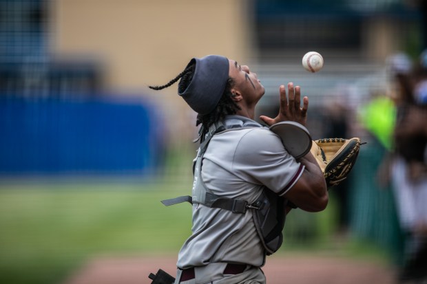 Brother Rice's Zion Rose makes a basket catch of a foul ball behind home plate against Mount Carmel during the Class 4A Reavis Sectional final in Burbank on Saturday, June 4, 2022. (Vincent D. Johnson / Daily Southtown).