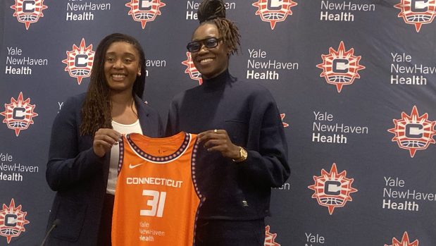 Sun GM Morgan Tuck (left) introduces fellow UConn alum Tina Charles as a free-agent acquisition for the Sun. At 36, Charles is still one of the WNBA's most productive post players. (Dom Amore/Hartford Courant).