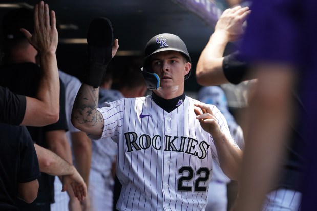 Rockies outfielder Mickey Moniak (22), celebrates with teammates after bringing a run in during a game against the Miami Marlins at Coors Field in Denver on Thursday, July 2, 2026. (Photo by Harmon Dobson/The Denver Post)