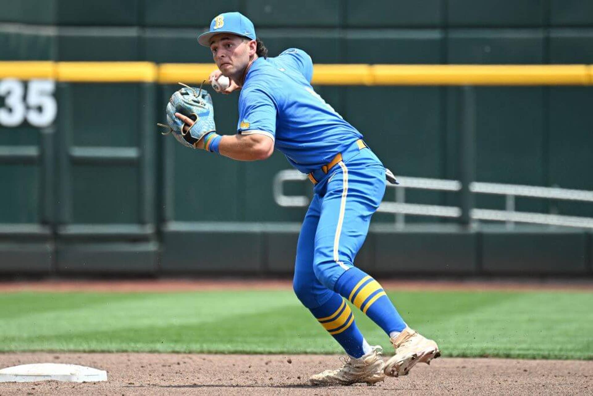 UCLA Bruins shortstop Roch Cholowsky completes a double play against the Murray State Racers.