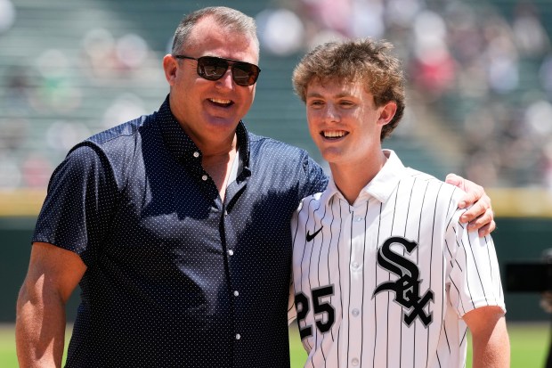 Chicago White Sox's Landon Thome, right, the 34th pick in the 2026 MLB draft, and his father, left, Hall of Famer Jim Thome, pose for a photo before a baseball game between the Athletics and the White Sox in Chicago, Sunday, July 12, 2026. (AP Photo/Nam Y. Huh)