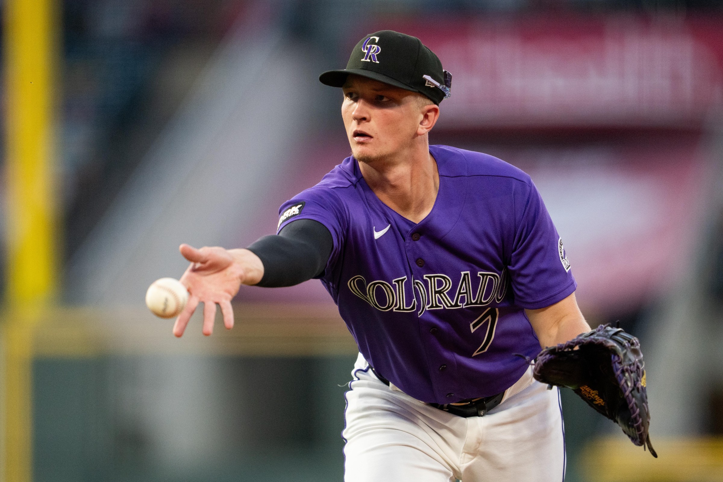 DENVER, CO - JUNE 22: TJ Rumfield #7 of the Colorado Rockies flips the ball to first base in a game against the Boston Red Sox at Coors Field on June 22, 2026 in Denver, Colorado. (Photo by Kyle Cooper/Colorado Rockies/Getty Images)