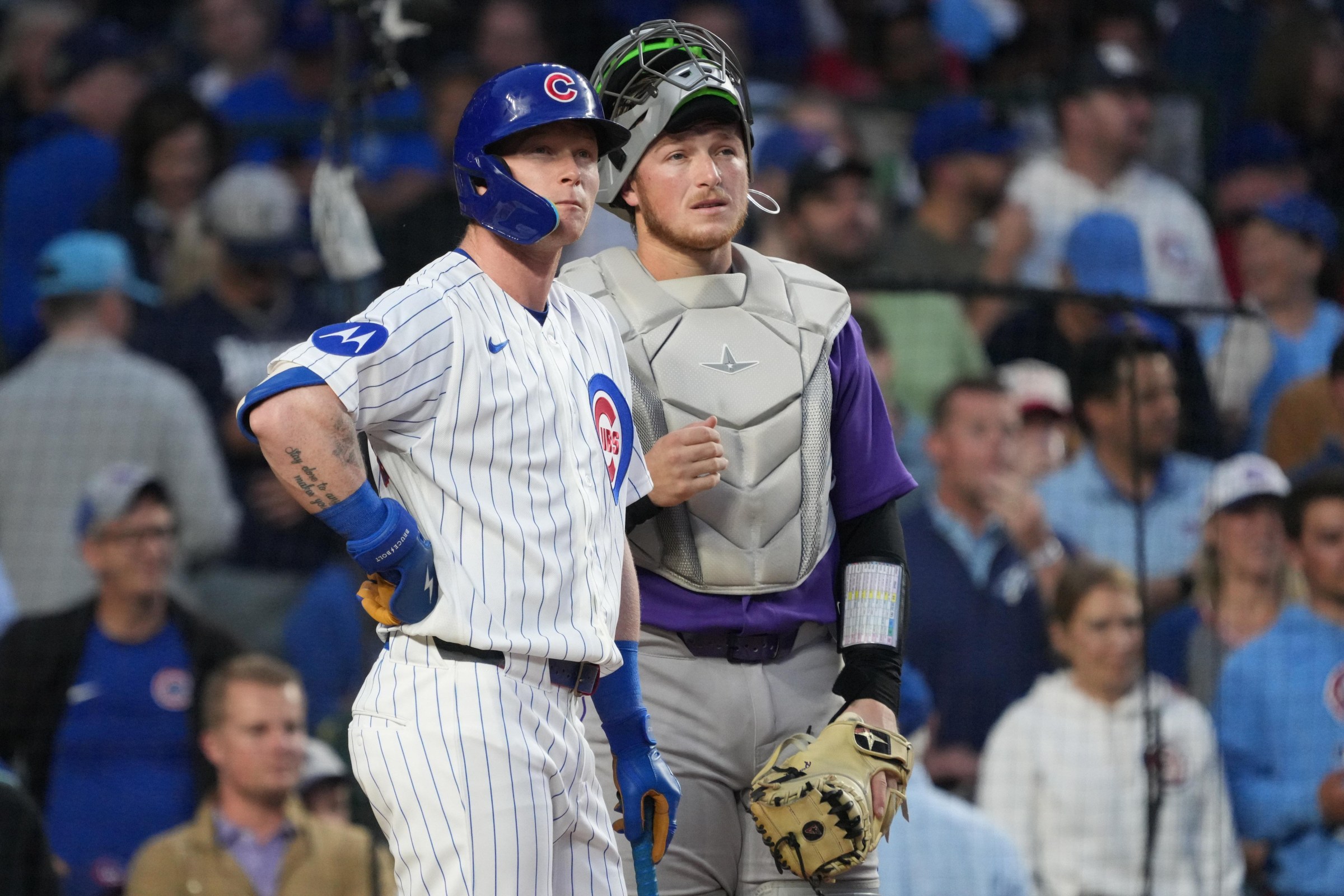 Jun 17, 2026; Chicago, Illinois, USA; Chicago Cubs center fielder Pete Crow-Armstrong (4) and Colorado Rockies catcher Hunter Goodman (15) watch a replay to see if a Armstrong’s home run was fair or foul against the during the fourth inning at Wrigley Field. Mandatory Credit: David Banks-Imagn Images