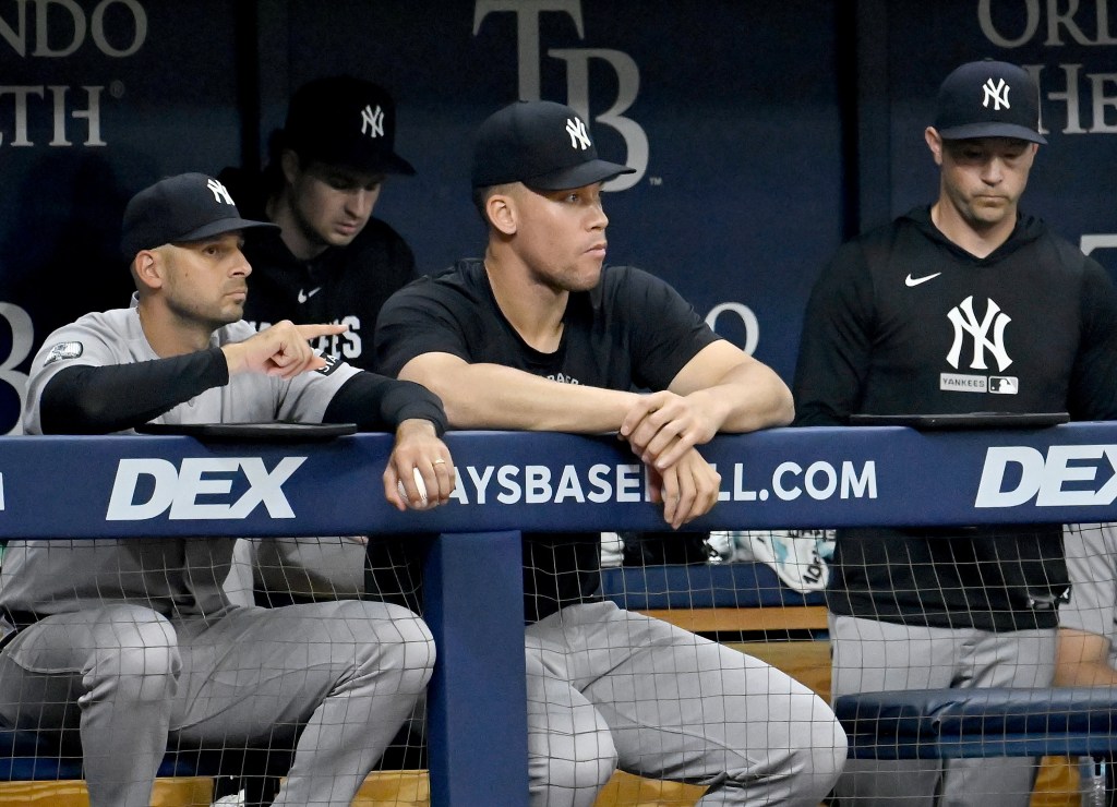 Jake Hirst and Aaron Judge in the dugout during a baseball game.