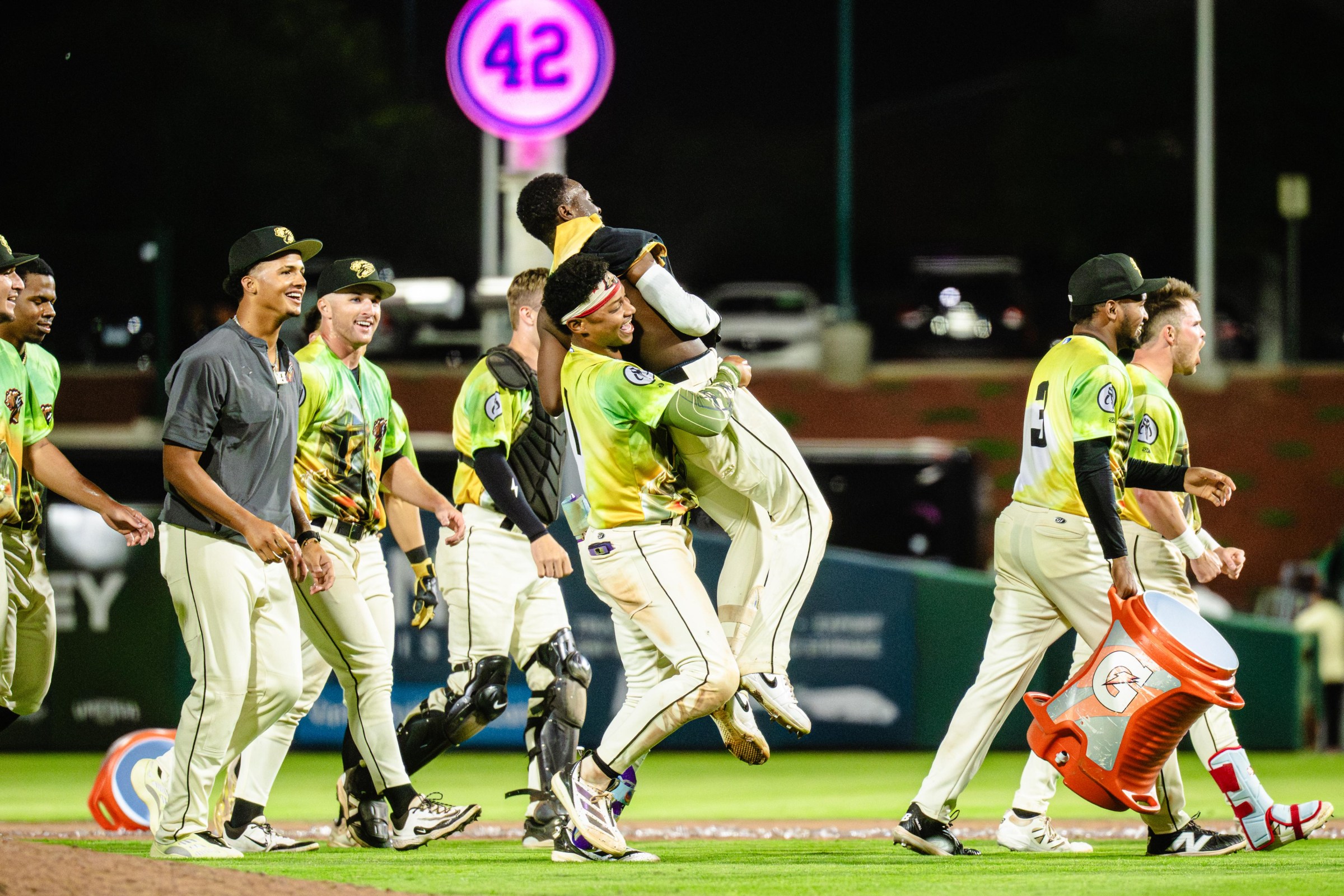 Roldy Brito (no. 1, middle) lifts a teammate in celebration of a victory.