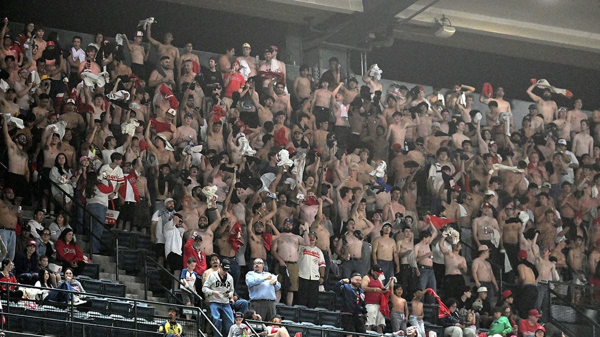 Shirtless fans cheer during a Los Angeles Angels game against the Colorado Rockies at Angel Stadium.