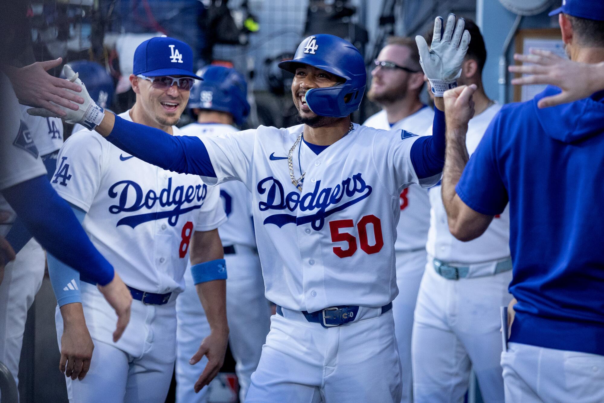 Dodgers shortstop Mookie Betts (center) celebrates with teammates after hitting a home run against the Royals on Wednesday.