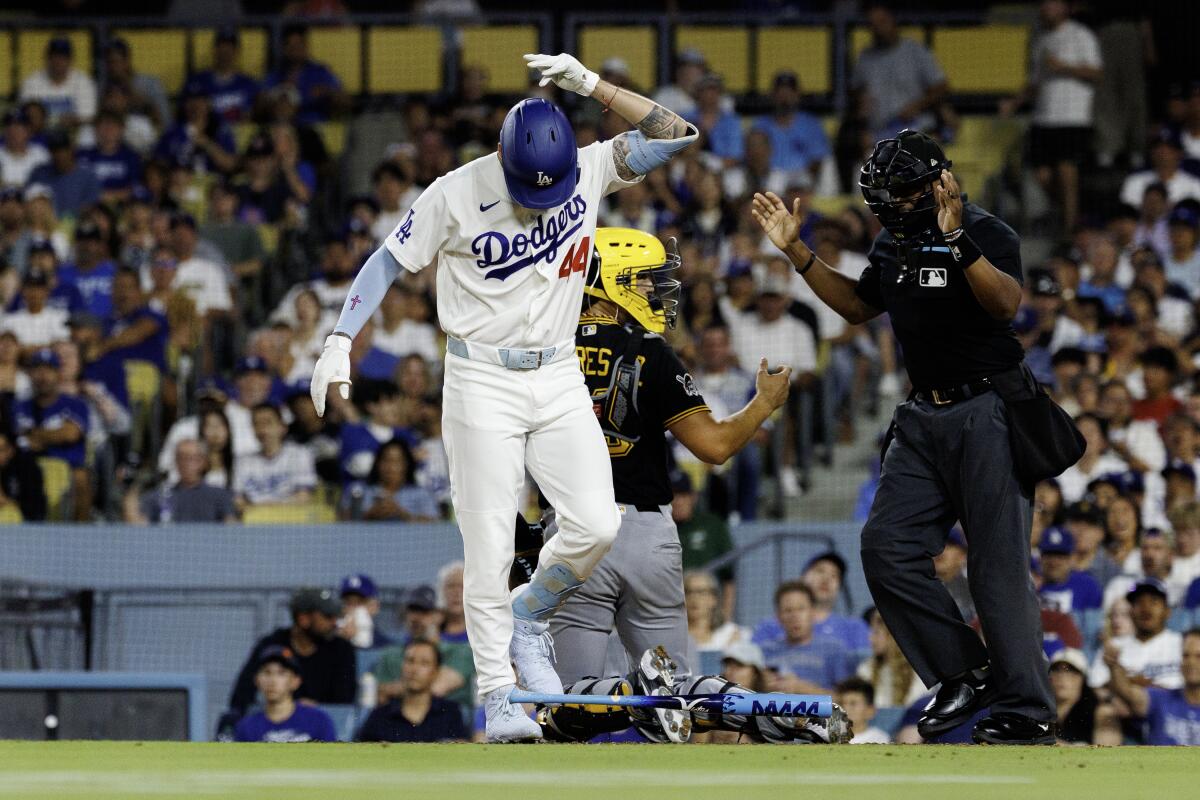 Dodgers center fielder Andy Pages drops his bat after taking a pitch off his left hand.