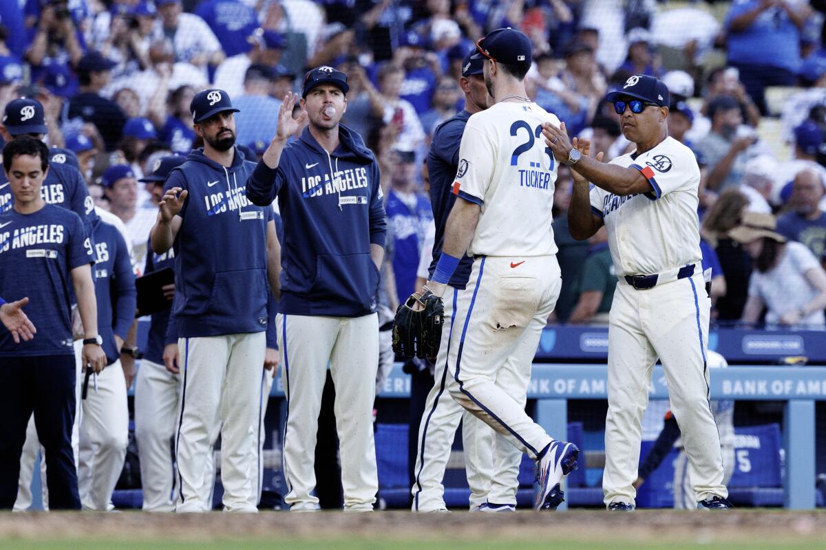 Dodgers' Kyle Tucker gets a pat on the back from Dodgers manager Dave Roberts after the Dodgers' win.