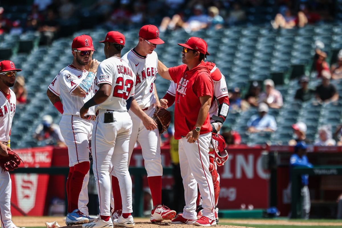 Angels coaching staff and infielders huddle at the mound to make a pitching change in the top of the sixth inning against the Kansas City Royals at Angel Stadium. 