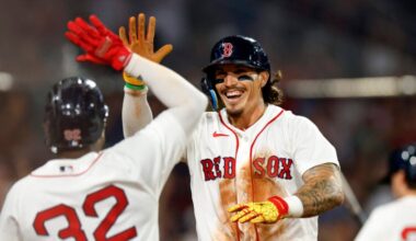Boston Red Sox left fielder Jarren Duran (right) high-fives shortstop Andruw Monasterio (32) after Duran scores against the Chicago White Sox during the seventh inning at Fenway Park on Aug. 5, 2026, in Boston.