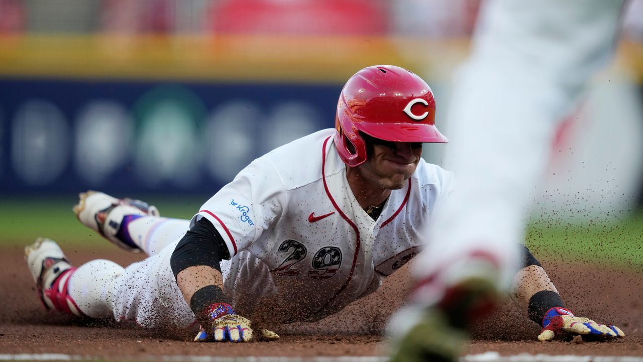 Cincinnati Reds' TJ Friedl dives into third base for a triple to score Jose Trevino during the second inning of a baseball game against the Baltimore Orioles in Cincinnati, Saturday, July 4, 2026. (AP Photo/Carolyn Kaster)