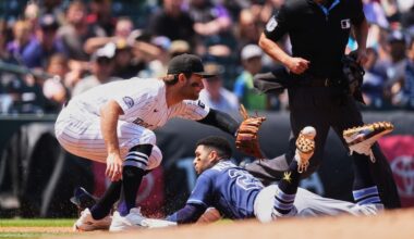 Colorado Rockies third baseman Kyle Karros, front left, fields the throw as Tampa Bay Rays' Victor Mesa Jr. slides safely into third base with a triple while third base umpire Alan Porter waits to make the call in the second inning of a baseball game in Denver, Wednesday, Aug. 5, 2026. (AP Photo/David Zalubowski)