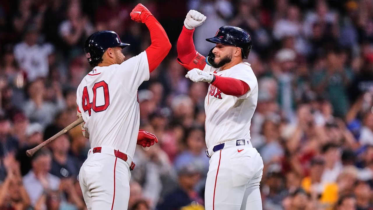 Boston Red Sox's Wilyer Abreu, right, is congratulated by Willson Contreras (40) after his solo home run during the third inning of a baseball game against the Chicago White Sox, Wednesday, Aug. 5, 2026, in Boston. (AP Photo/Charles Krupa)