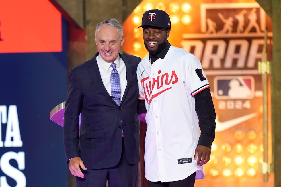 Major League Baseball Commissioner Rob Manfred, left, and Kaelen Culpepper, right, pose for a...