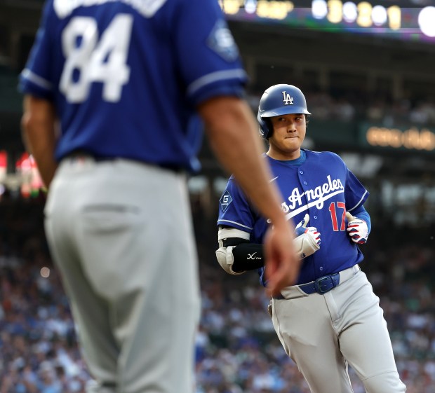 Los Angeles Dodgers designated hitter Shohei Ohtani (17) heads to the dugout after grounding out in the first inning of a game against the Chicago Cubs at Wrigley Field in Chicago on Aug. 4, 2026. (Chris Sweda/Chicago Tribune)