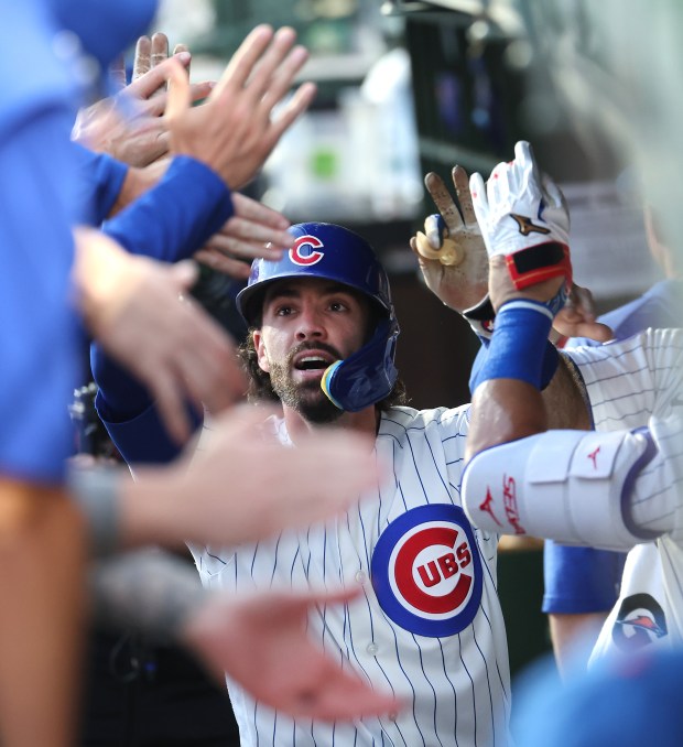 Chicago Cubs shortstop Dansby Swanson is congratulated in the dugout after hitting a solo home run in the third inning of a game against the Los Angeles Dodgers at Wrigley Field in Chicago on Aug. 4, 2026. (Chris Sweda/Chicago Tribune)