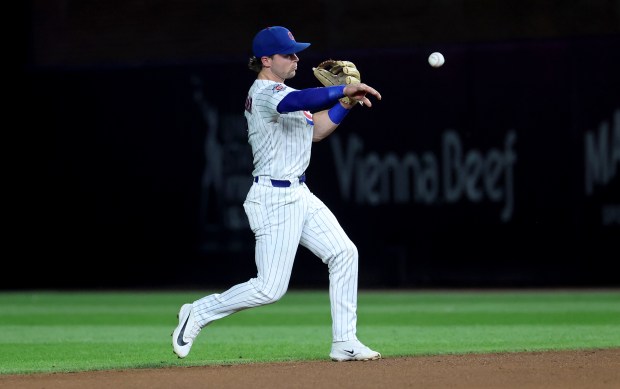 Chicago Cubs second baseman Nico Hoerner (2) makes a throw to first base on a ground out by the Los Angeles Dodgers in the seventh inning of a game at Wrigley Field in Chicago on Aug. 4, 2026. (Chris Sweda/Chicago Tribune)