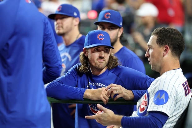 New Chicago Cubs pitcher Kevin Gausman (center) talks with third baseman Alex Bregman (right) in the seventh inning of a game at Wrigley Field in Chicago on Aug. 4, 2026. (Chris Sweda/Chicago Tribune)