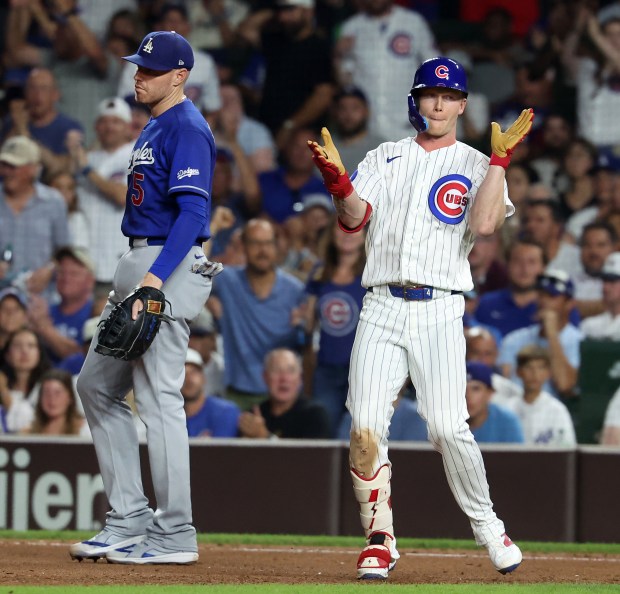 Chicago Cubs center fielder Pete Crow-Armstrong (4) celebrates at first base after driving in a run on a single in the seventh inning of a game against the Los Angeles Dodgers at Wrigley Field in Chicago on Aug. 4, 2026. (Chris Sweda/Chicago Tribune)