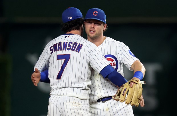Chicago Cubs shortstop Dansby Swanson (7) and second baseman Nico Hoerner celebrate after their victory over the Los Angeles Dodgers at Wrigley Field in Chicago on Aug. 4, 2026. (Chris Sweda/Chicago Tribune)
