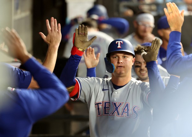 Texas Rangers first baseman Joc Pederson (3) is congratulated by his teammates in the dugout after hitting a two-run home run in the third inning of a game against the Chicago White Sox at Rate Field in Chicago on Aug. 26, 2026. (Chris Sweda/Chicago Tribune)