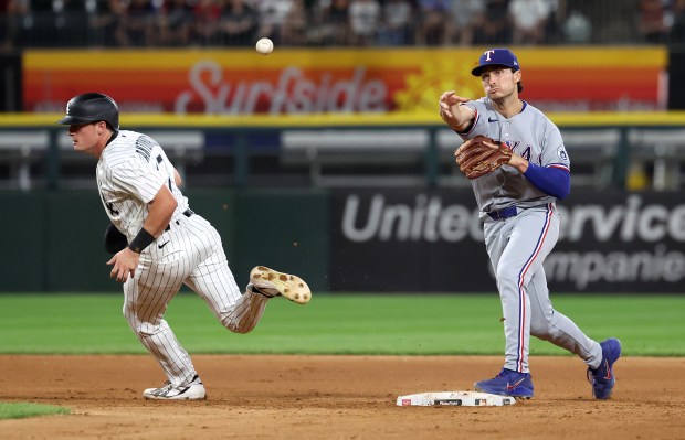 Texas Rangers second baseman Justin Foscue (14) throws to first base after forcing out Chicago White Sox left fielder Sam Antonacci (17) at second base in the sixth inning of a game at Rate Field in Chicago on Aug. 26, 2026. (Chris Sweda/Chicago Tribune)