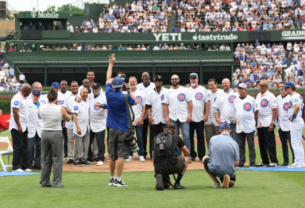 Members of the Chicago Cubs 150th anniversary team gather for pictures during a ceremony before a Cubs-Reds game at Wrigley Field on Aug. 29, 2026, in Chicago. (John J. Kim/Chicago Tribune)