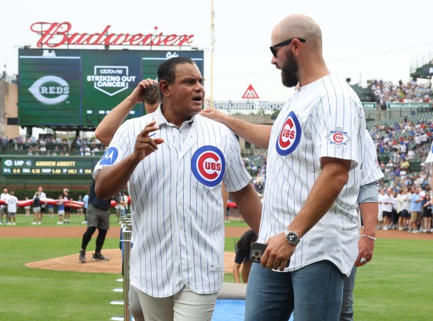 Sammy Sosa, center, and Jon Lester talk while walking with fellow former Cubs players during the Chicago Cubs 150th anniversary team ceremony before a Cubs-Reds game at Wrigley Field on Aug. 29, 2026, in Chicago. (John J. Kim/Chicago Tribune)