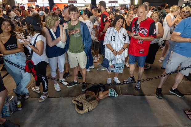 Sabastian Elsey, 5, naps in the concourse during a rain delay between the Cleveland Guardians and Chicago White Sox at Rate Field in Chicago, Sunday, Aug. 9, 2026. (Arthur Maiorella/Chicago Tribune)