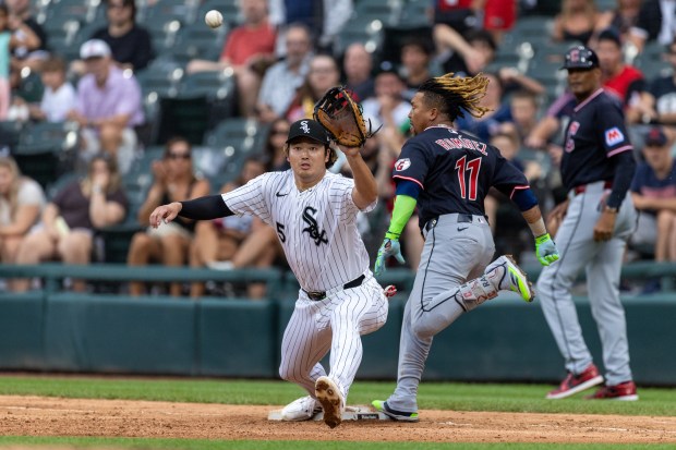 Chicago White Sox first baseman Munetaka Murakami (5) reaches for a ball while trying to get Cleveland Guardians third baseman José Ramírez (11) out during the top of the seventh inning of a baseball game between the Cleveland Guardians and Chicago White Sox at Rate Field in Chicago, Sunday, Aug. 9, 2026. (Arthur Maiorella/Chicago Tribune)
