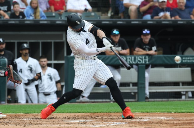 White Sox designated hitter Randal Grichuk connects for a two-run double against the Reds in the second inning at Rate Field on Aug. 13, 2026, in Chicago. (John J. Kim/Chicago Tribune)