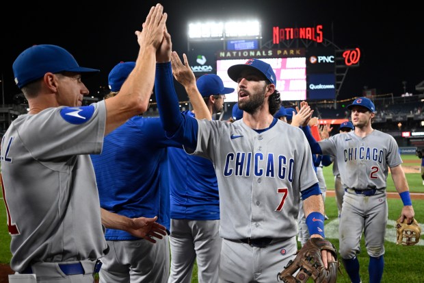 Cubs manager Craig Counsell, left, high-fives Dansby Swanson after a 12-6 win against the Nationals on Wednesday, Aug. 12, 2026, in Washington. (John McDonnell/AP)