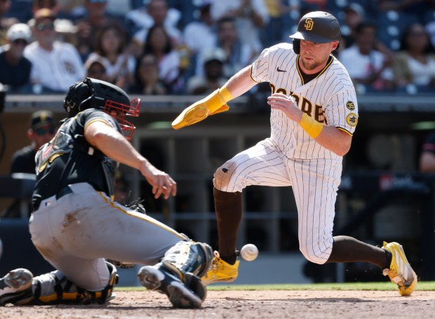 San Diego, CA - August 26: Jake Cronenworth #9 of the San Diego Padres is about to be tagged out by Rafael Flores Jr. #43 of the Pittsburgh Pirates in the eighth inning at Petco Park on August 26, 2026 in San Diego, CA. (K.C. Alfred / The San Diego Union-Tribune)