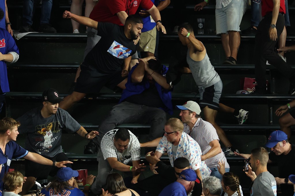 Fans from the Chicago White Sox and Chicago Cubs fight in the bleachers of Wrigley Field.