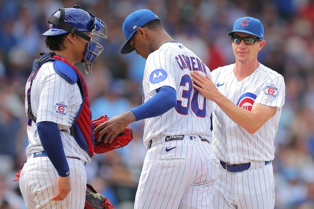 Chicago Cubs manager Craig Counsell, right, pulls Edward Cabrera, center, during the fourth inning of a baseball game against the St. Louis Cardinals, Sunday, Aug. 16, 2026, in Chicago. (AP Photo/Melissa Tamez)