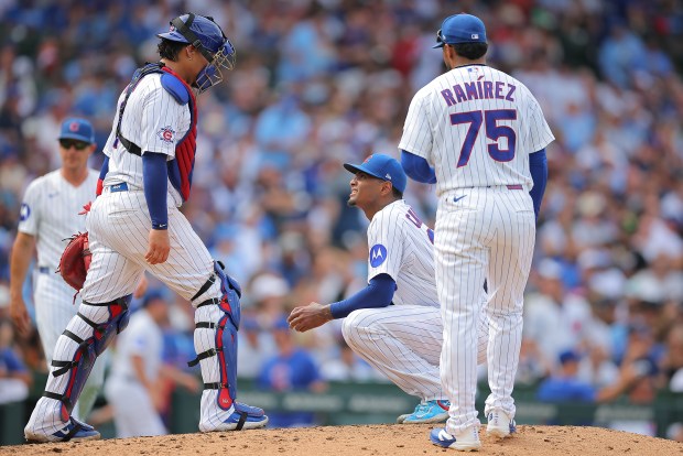 Chicago Cubs' Edward Cabrera, center, looks at catcher Miguel Amaya during the fourth inning of a game against the St. Louis Cardinals on Sunday, Aug. 16, 2026, in Chicago. (AP Photo/Melissa Tamez)