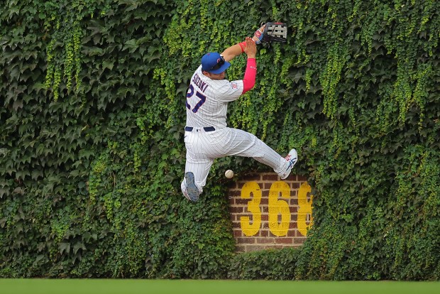 Chicago Cubs' Seiya Suzuki misses a two-RBI double hit by St. Louis Cardinals' Jordan Walker during the eighth inning of a baseball game, Sunday, Aug. 16, 2026, in Chicago. (AP Photo/Melissa Tamez)